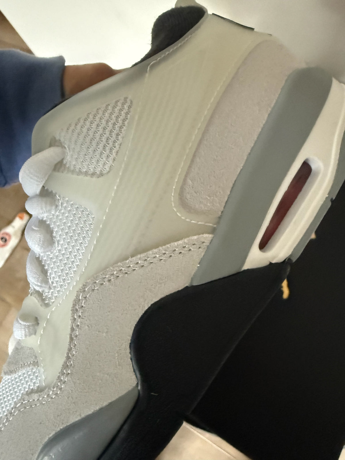 D’s Laces Jordan 4 RM sneakers in light bone, grey, and white with suede and mesh detailing and visible Air-Sole unit